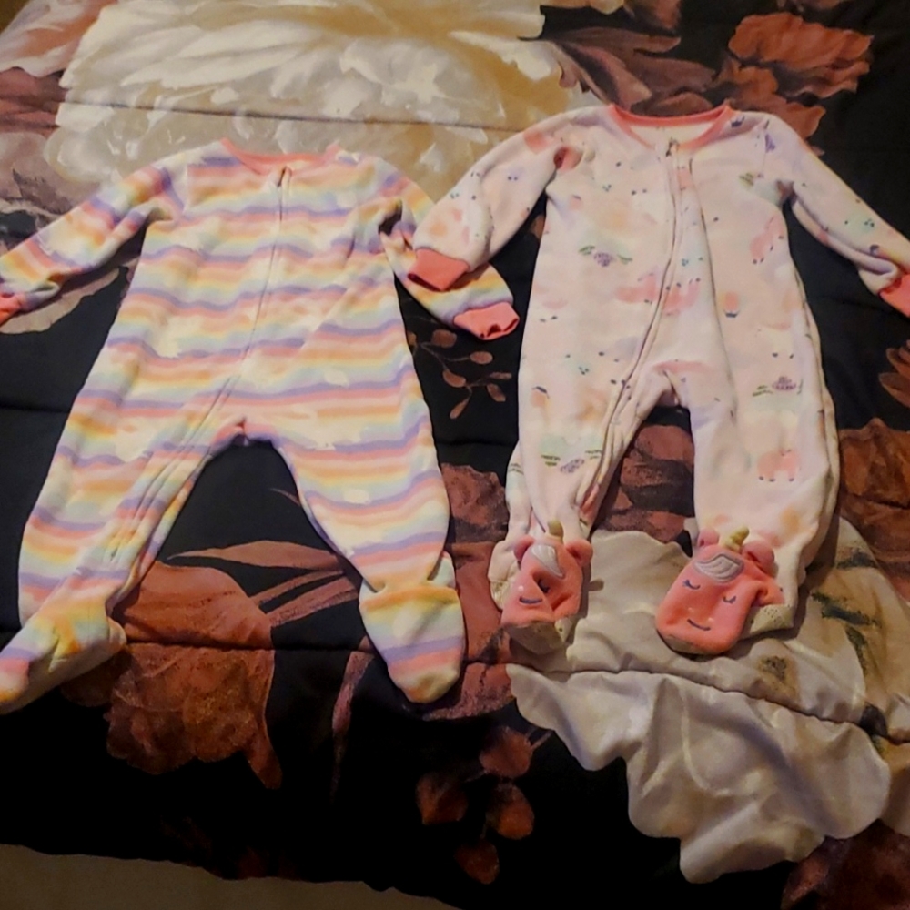 2 pajama zip up footies. One unicorns other stripes with unicorns.